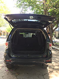 black SUV toyota fortuner 2105 rear with open hatch view