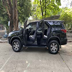 left view doors open black fortuner suv for hire